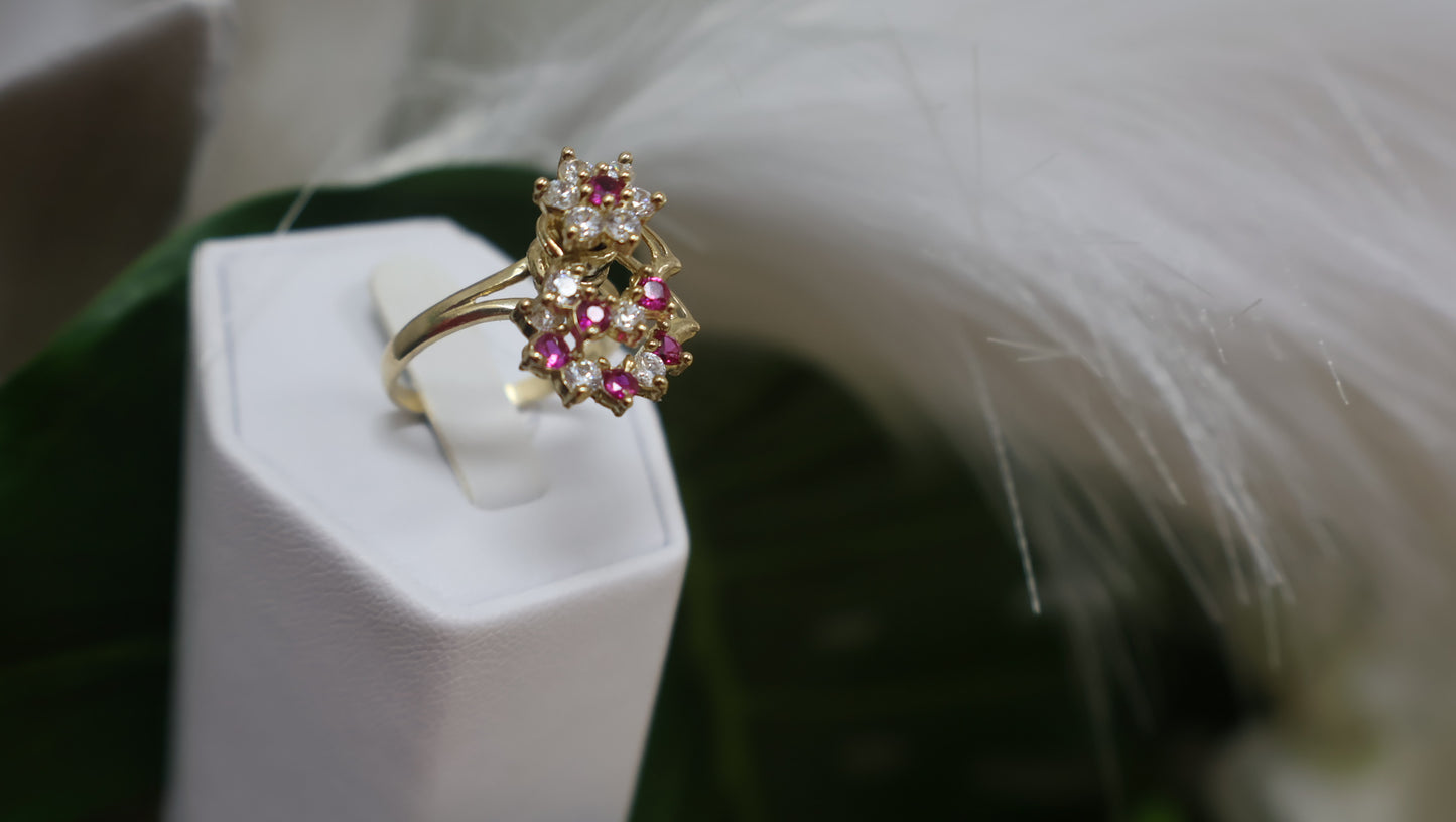 anillo de mujer giratorio con sirconia de color blanca y rosada en oro 10k