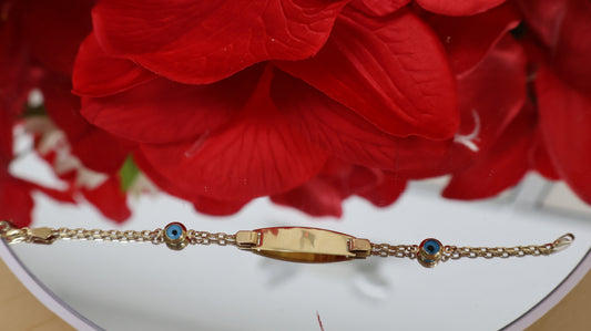 Manilla de nino con placa de ojitos en azul en oro de 14k